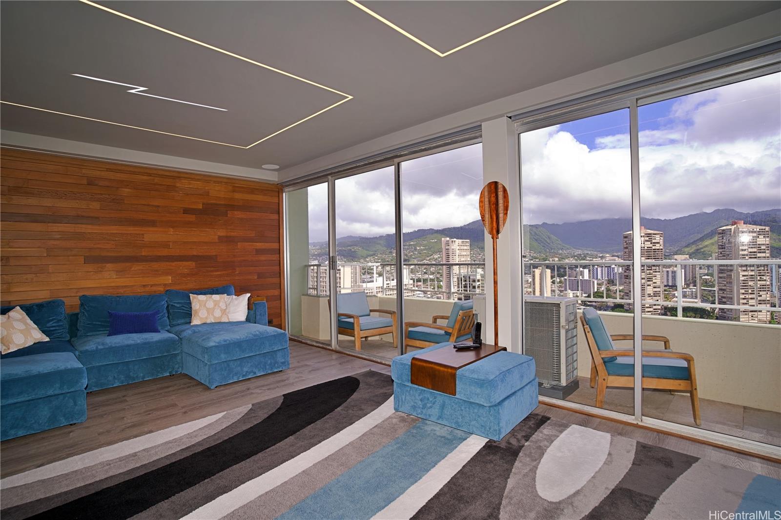 2211 Ala Wai Boulevard, Unit P6 Honolulu, HI 96815 - Photo 9 of 24 a living room with furniture and a floor to ceiling window