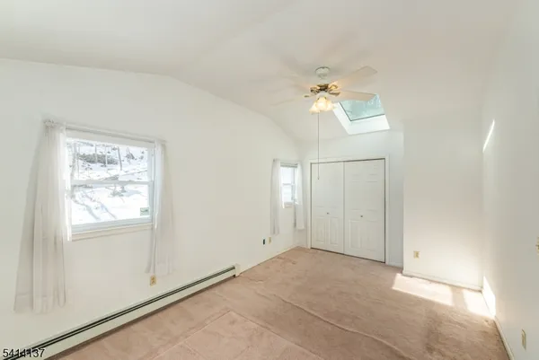 a view of a room with a ceiling fan and a window
