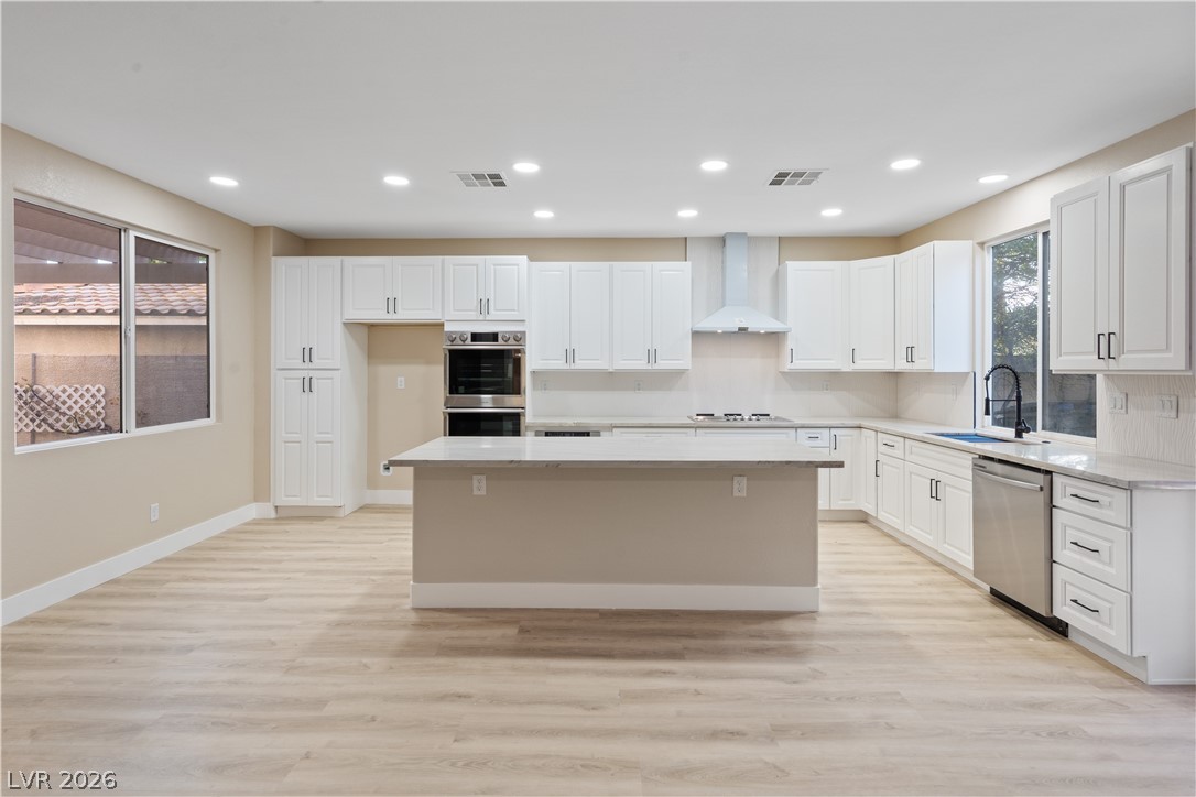 1662 Ravanusa Drive Henderson, NV 89052 - Photo 14 of 74 Culinary dreams come alive in this well-lit kitchen with sleek appliances and ample counter space.