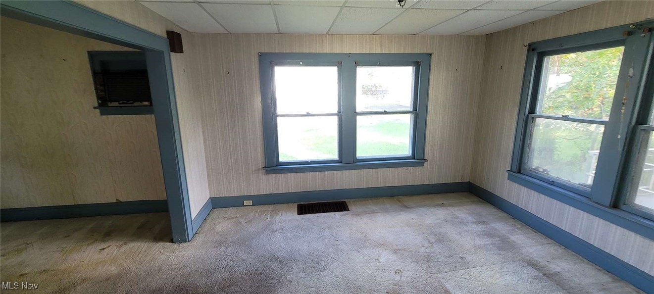 927 Yellowstone Road Cleveland Heights, OH 44121 - Photo 4 of 13 Carpeted empty room with a drop ceiling