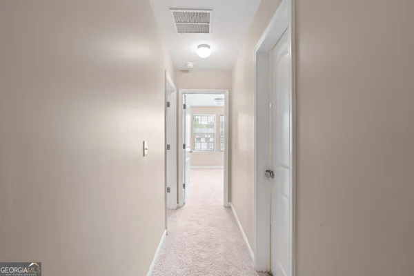 a view of a bathroom from a hallway
