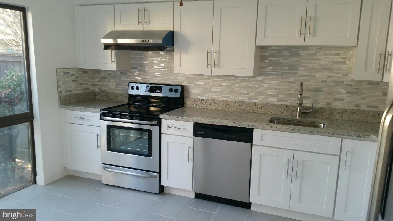 11655 Newbridge Court Reston, VA 20191 - Photo 11 of 30 a kitchen with cabinets appliances and a sink