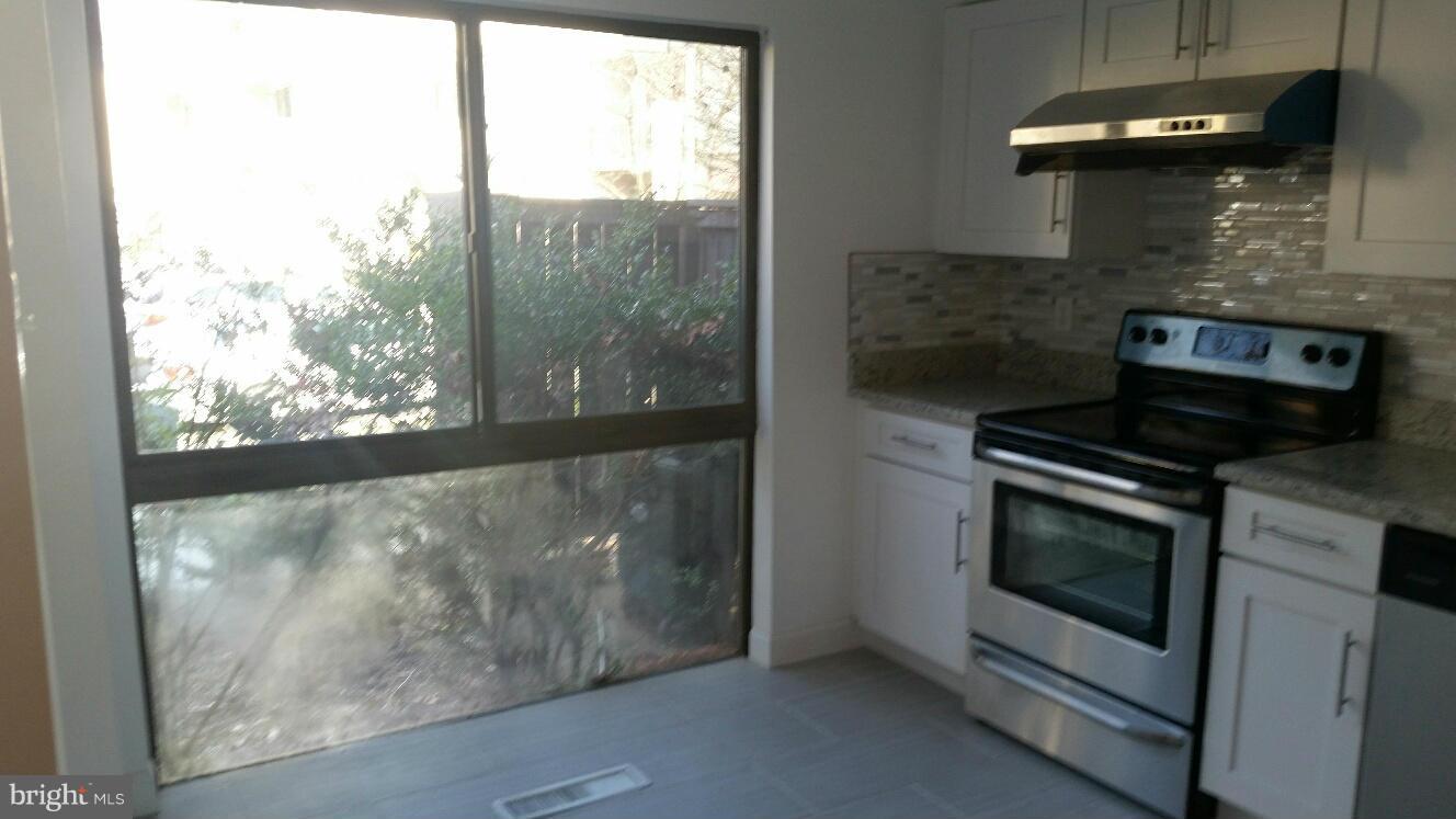 11655 Newbridge Court Reston, VA 20191 - Photo 12 of 30 a kitchen with a stove and a window