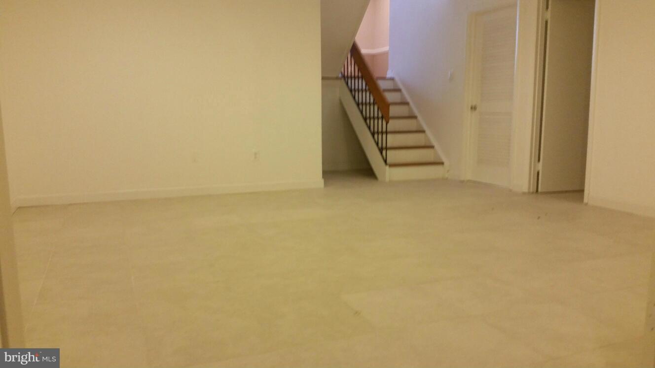 11655 Newbridge Court Reston, VA 20191 - Photo 18 of 30 an empty room with staircase and white walls