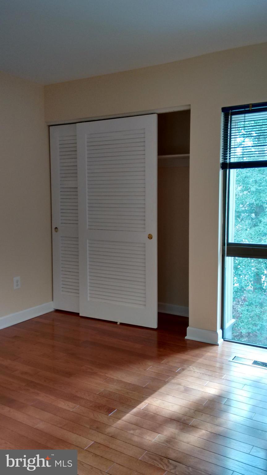 11655 Newbridge Court Reston, VA 20191 - Photo 19 of 30 an empty room with wooden floor and windows