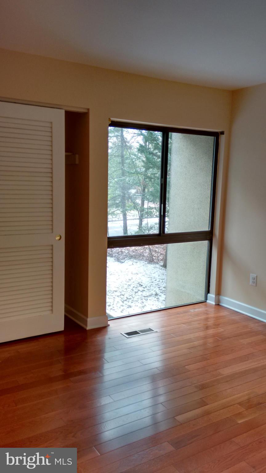 11655 Newbridge Court Reston, VA 20191 - Photo 21 of 30 wooden floor in an empty room with a window