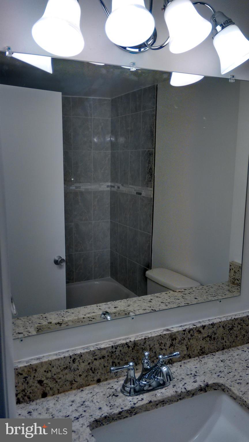 11655 Newbridge Court Reston, VA 20191 - Photo 23 of 30 a bathroom with a sink and a mirror