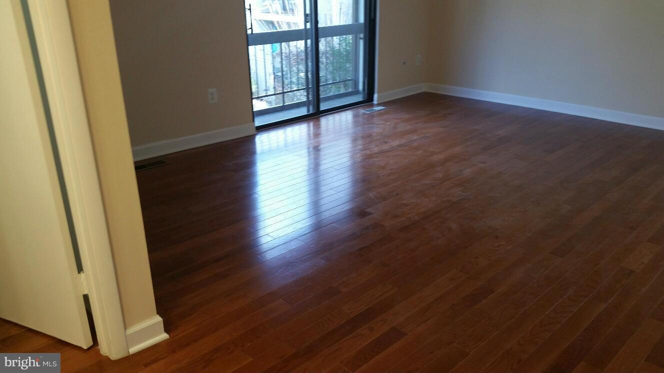 11655 Newbridge Court Reston, VA 20191 - Photo 24 of 30 a view of an empty room with wooden floor and a window