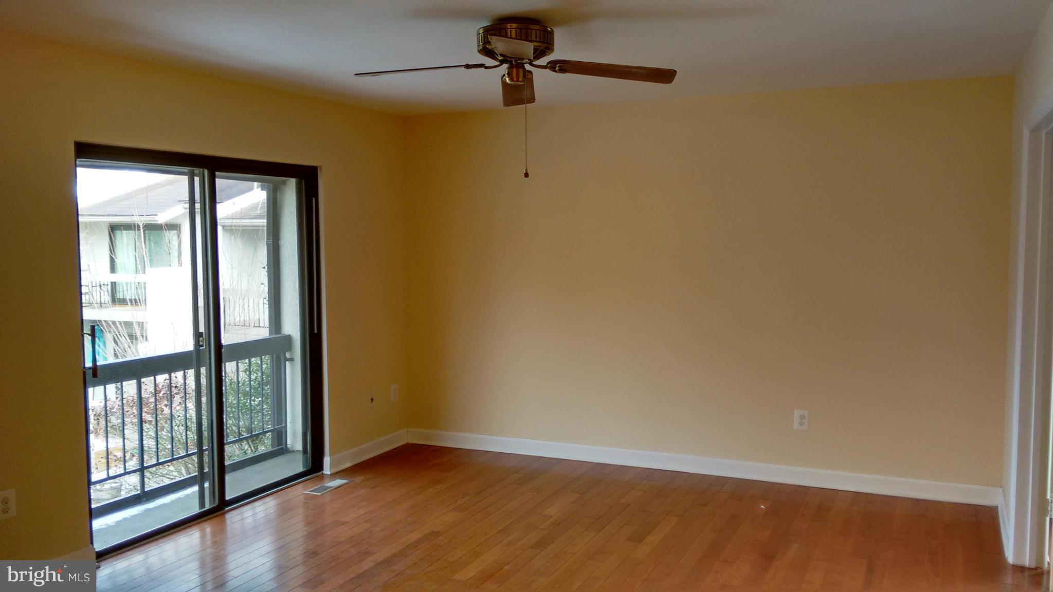 11655 Newbridge Court Reston, VA 20191 - Photo 25 of 30 a view of an empty room with wooden floor and a window