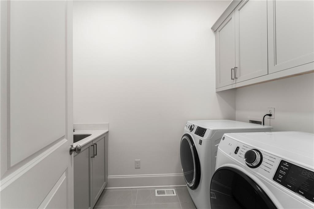7170 Lullwater Road Cumming, GA 30040 - Photo 40 of 86 a utility room with dryer and washer