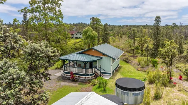 a view of a swimming pool with lawn chairs under an umbrella