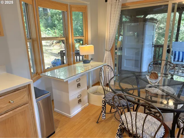 a dining room with furniture and a floor to ceiling window