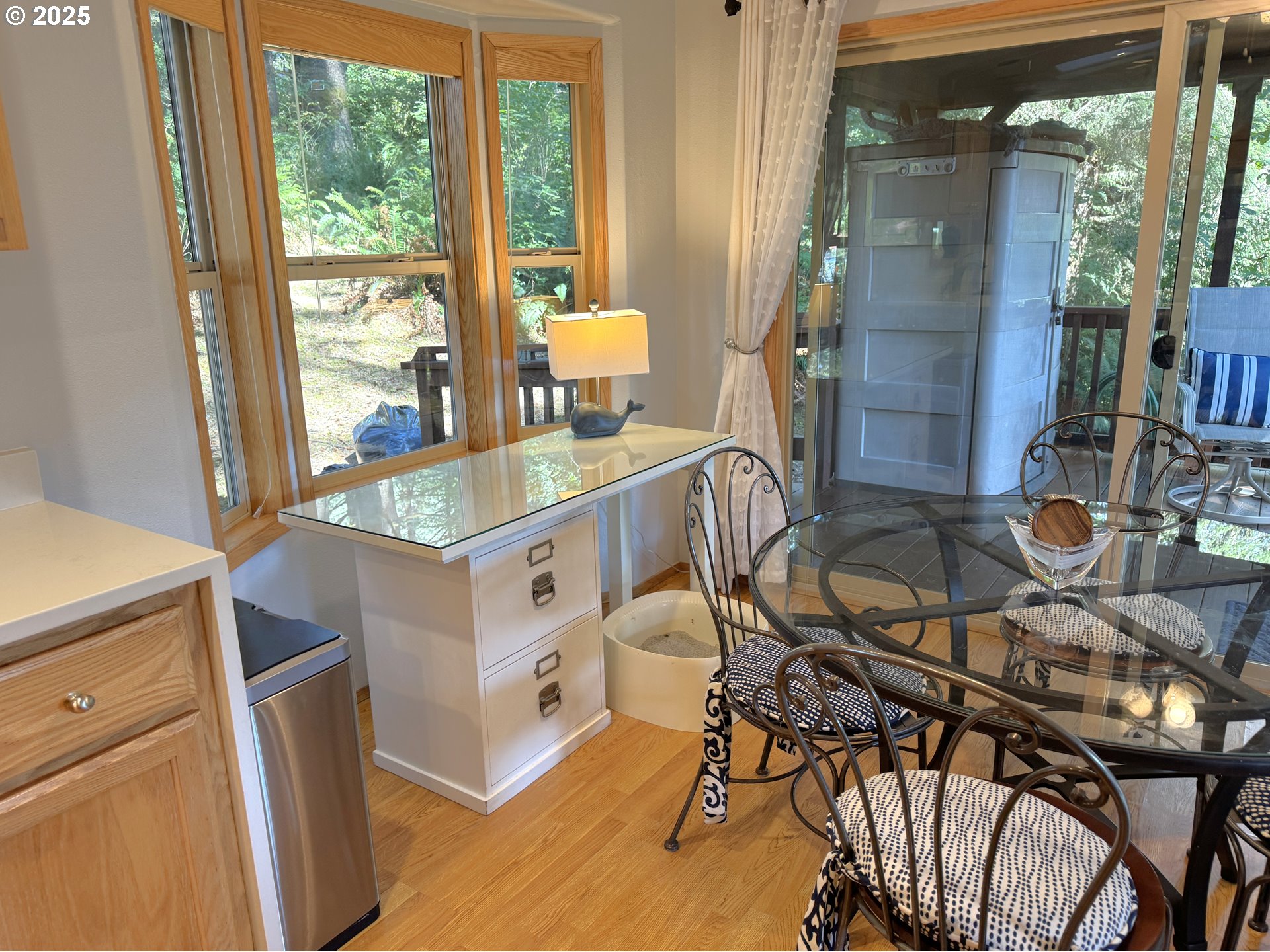 19921 Whaleshead Road, Unit EL1 Brookings, OR 97415 - Photo 11 of 29 a dining room with furniture and a floor to ceiling window