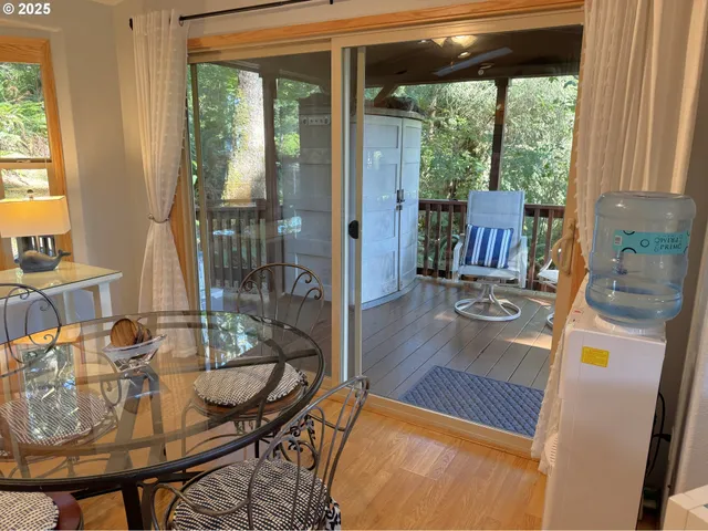 a view of a dining room with furniture wooden floor and a potted plant
