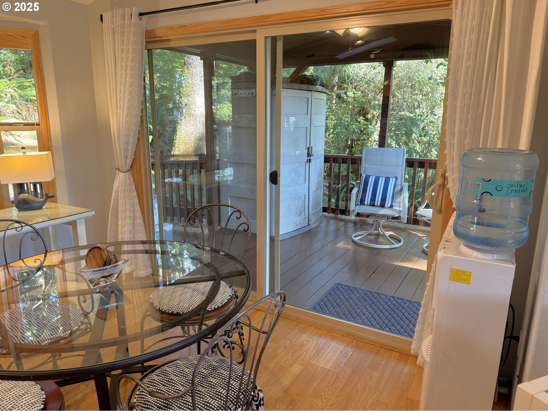 19921 Whaleshead Road, Unit EL1 Brookings, OR 97415 - Photo 12 of 29 a view of a dining room with furniture wooden floor and a potted plant