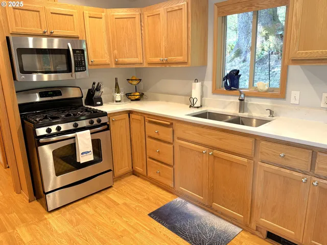 a kitchen with sink cabinets and stainless steel appliances