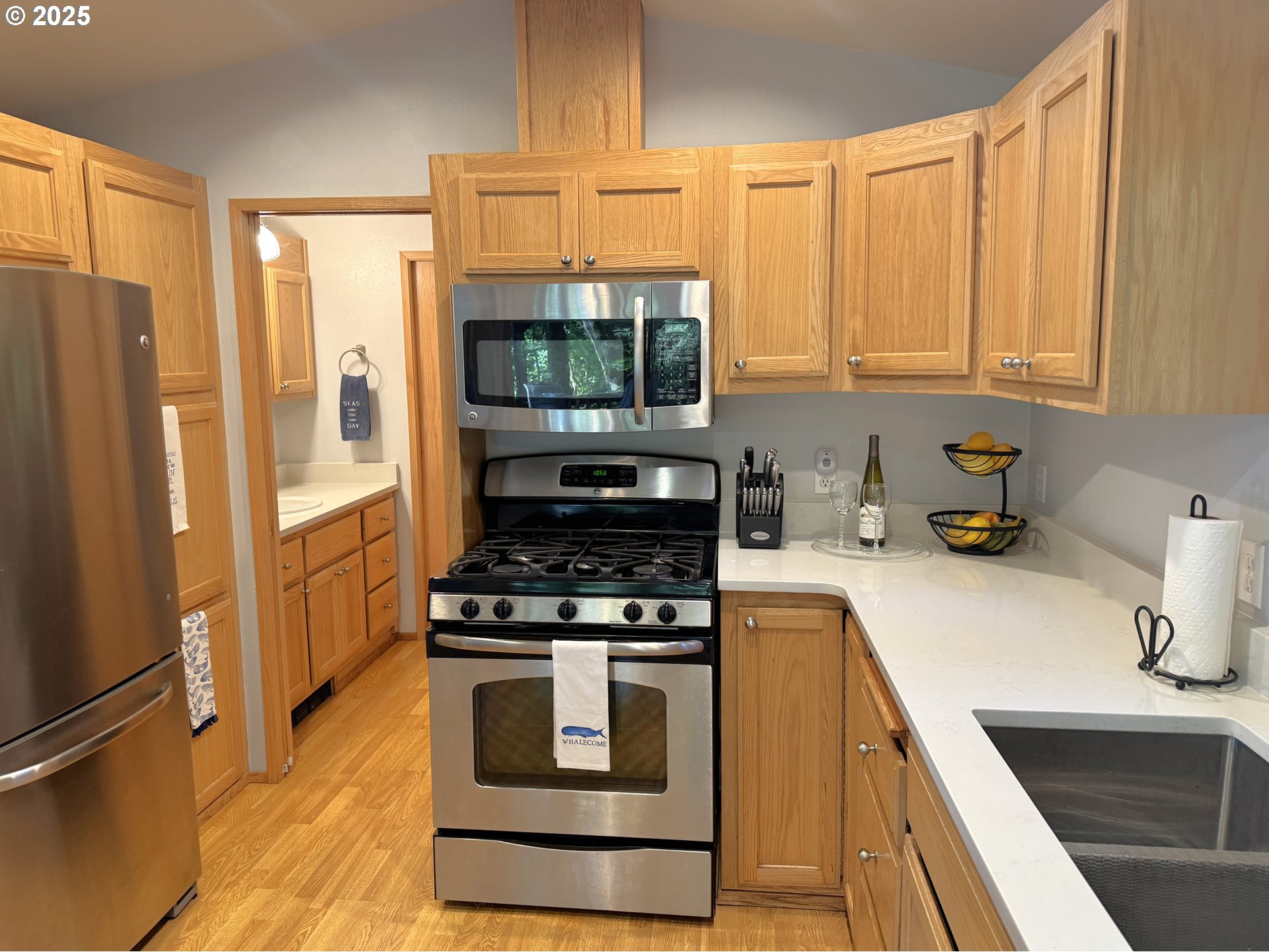 19921 Whaleshead Road, Unit EL1 Brookings, OR 97415 - Photo 14 of 29 a kitchen with granite countertop a stove a sink dishwasher and a refrigerator