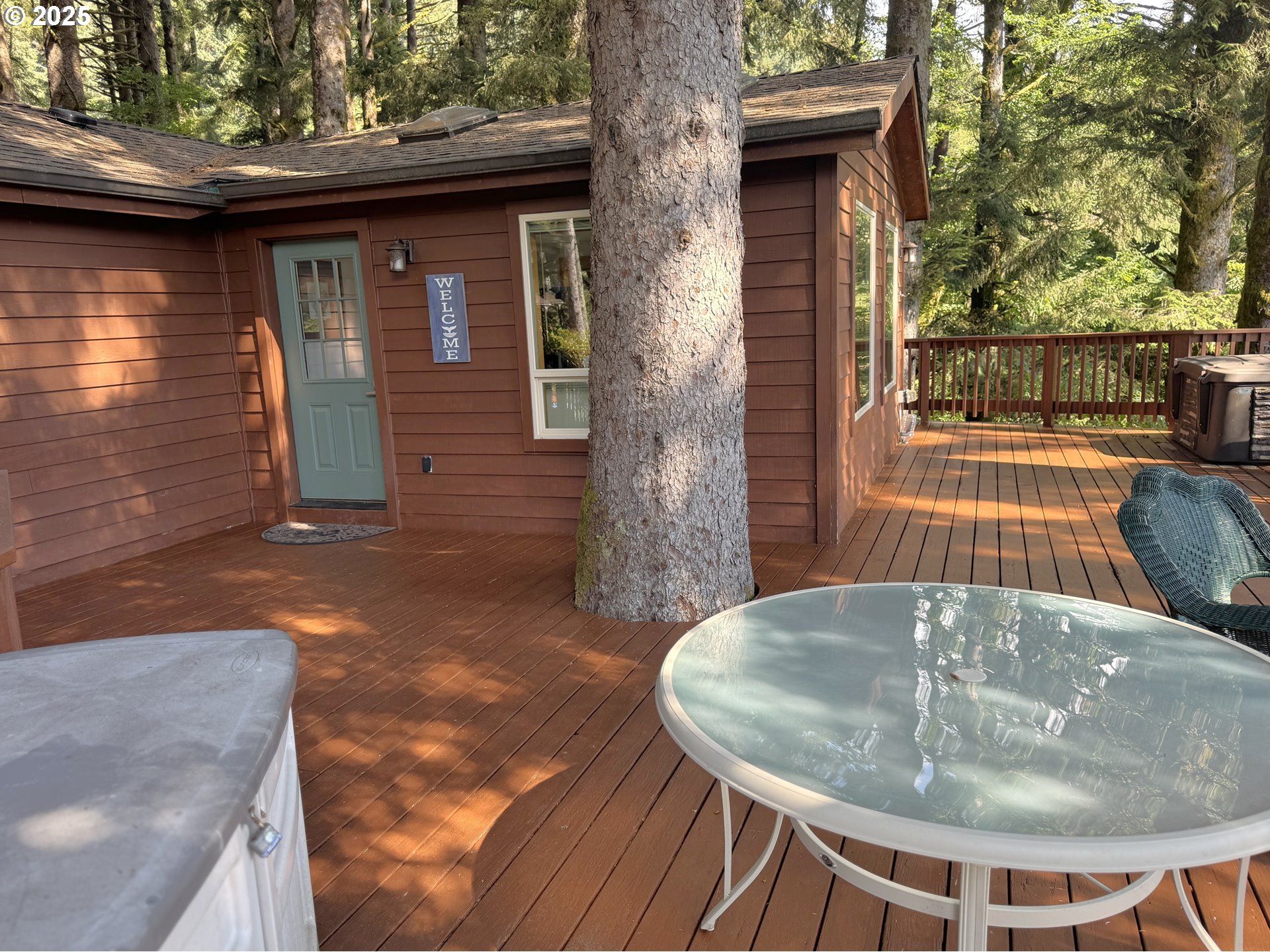 19921 Whaleshead Road, Unit EL1 Brookings, OR 97415 - Photo 23 of 29 a backyard of a house with table and chairs
