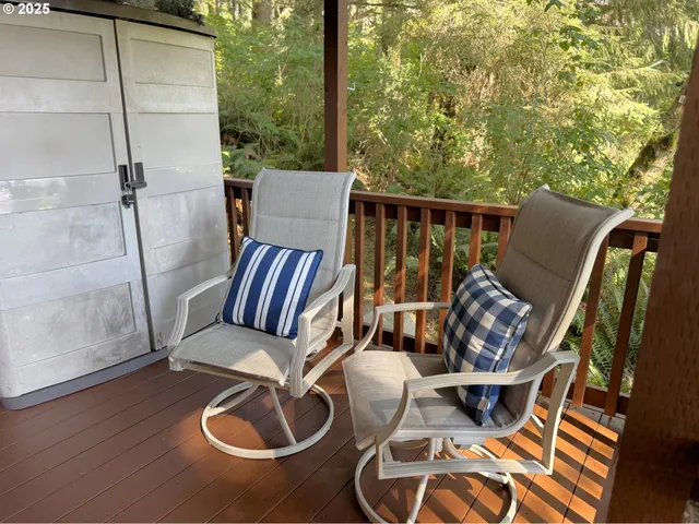a balcony with furniture and wooden floor