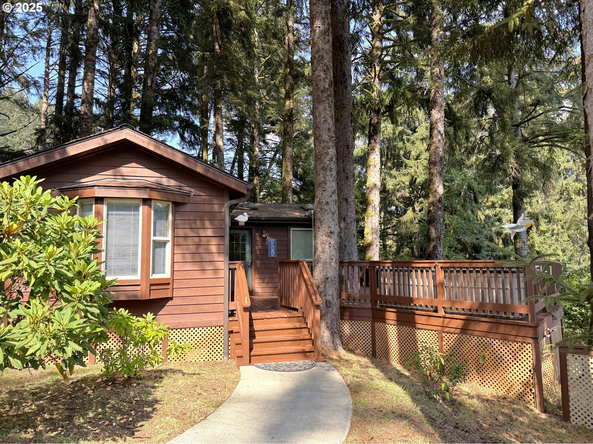 19921 Whaleshead Road, Unit EL1 Brookings, OR 97415 - Photo 3 of 29 a view of a house with pool and wooden floor