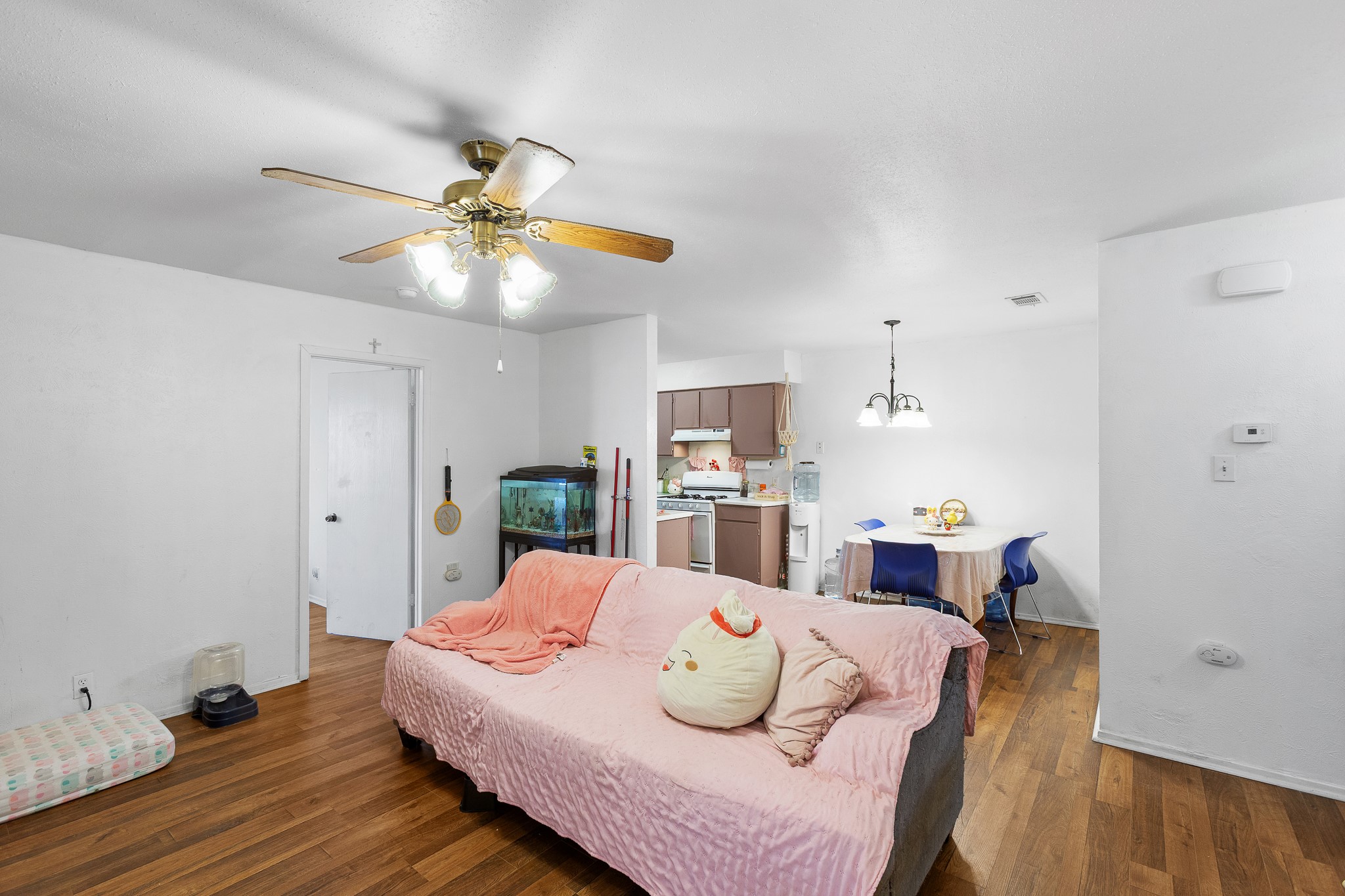 606 Misty Morning Way, Unit A AND B Round Rock, TX 78664 - Photo 7 of 22 Living room featuring dark wood-style flooring, a chandelier, and ceiling fan