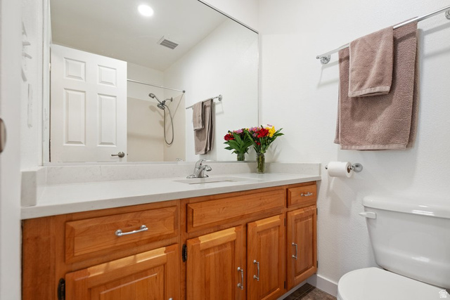 865 South 325 West Orem, UT 84058 - Photo 22 of 38 Bathroom featuring a wood-finish vanity with a light-colored countertop, integrated sink, and chrome fixtures