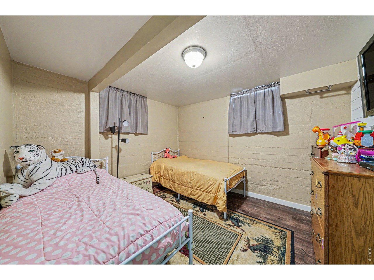 1430 30th Street Road Greeley, CO 80631 - Photo 17 of 22 a bedroom with two beds and a desk