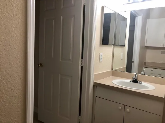 a front view of a house with a tree