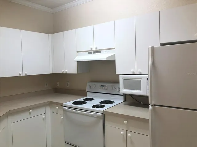 a kitchen with a stove and a refrigerator