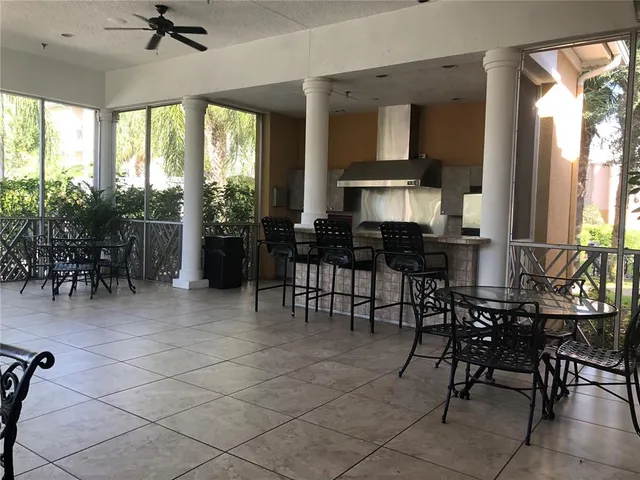 a view of swimming pool with outdoor seating and house in the background