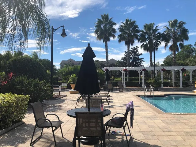 a view of a building with yard and sitting area