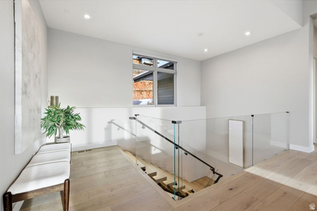 2002 East Outlaw Road Kamas, UT 84036 - Photo 42 of 65 Upper landing featuring hardwood flooring and a modern glass panel railing system with a dark handrail