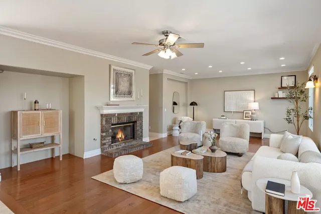 a living room with fireplace furniture and a wooden floor