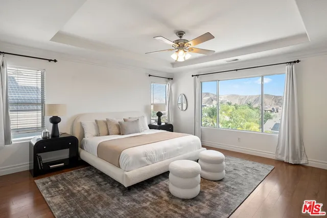 a bedroom with a bed and a large window