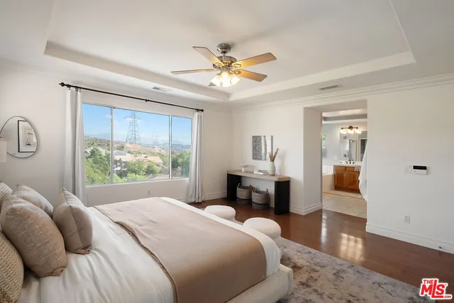 a bedroom with a bed and a chandelier