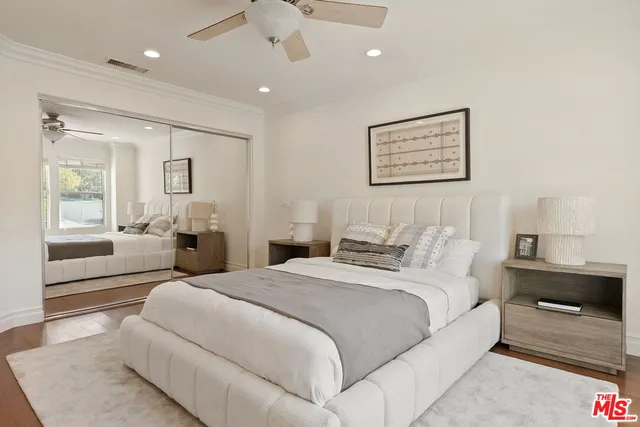 a spacious bedroom with a bed and a large window