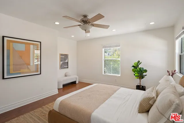 a bedroom with a bed and ceiling fan