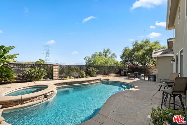 a view of a backyard with sitting area