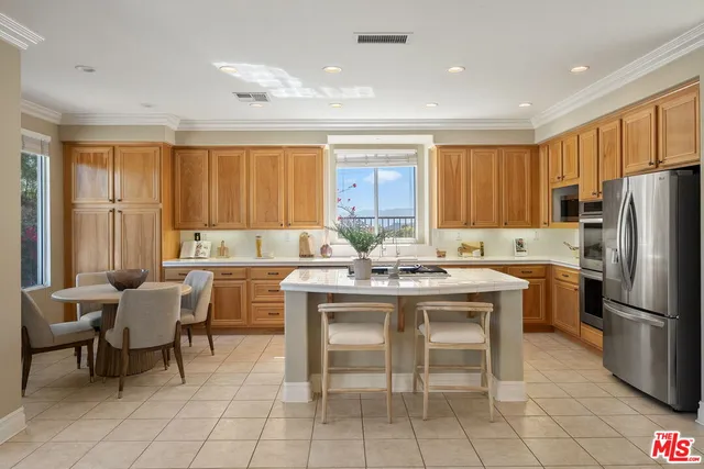 a kitchen with a sink window and refrigerator