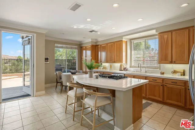 a kitchen with a stove a sink a counter top space and dining table