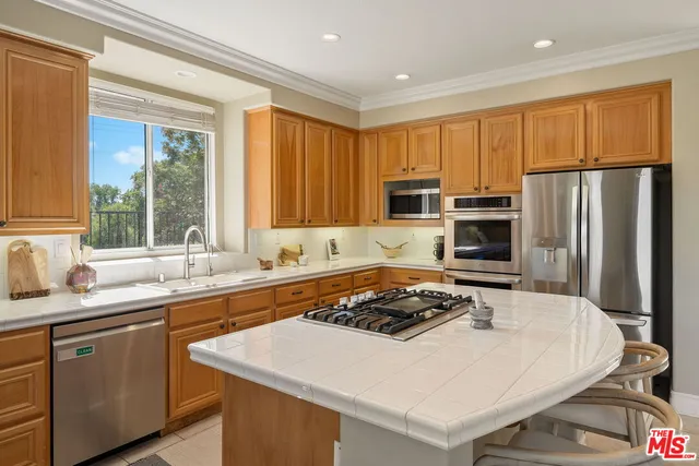a kitchen with a appliances a sink and cabinets