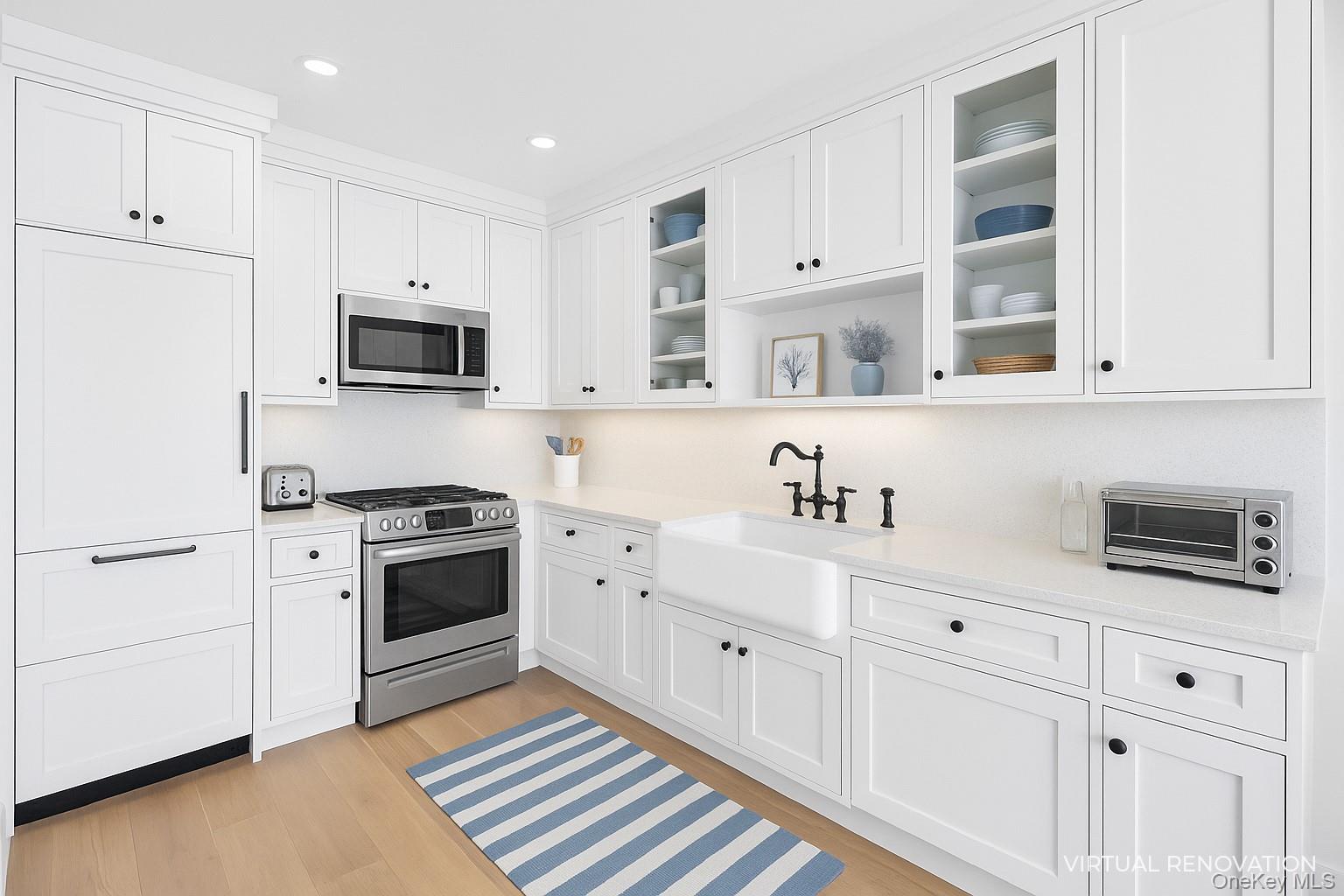 279 Dune Road, Unit 2 Westhampton Beach, NY 11978 - Photo 16 of 45 a kitchen with granite countertop white cabinets and stainless steel appliances