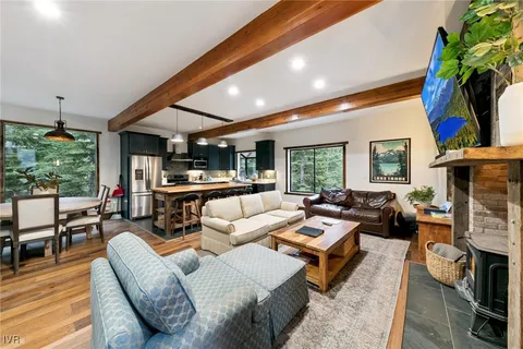 a living room with furniture fireplace and a large window