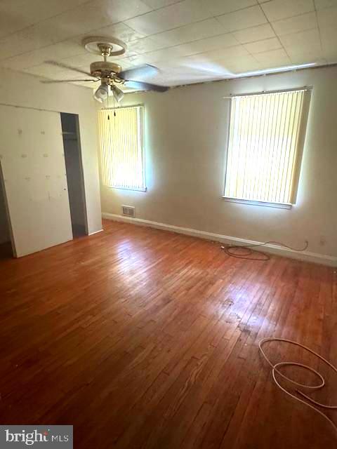 3582 Dudley Avenue Baltimore, MD 21213 - Photo 8 of 13 an empty room with wooden floor and windows