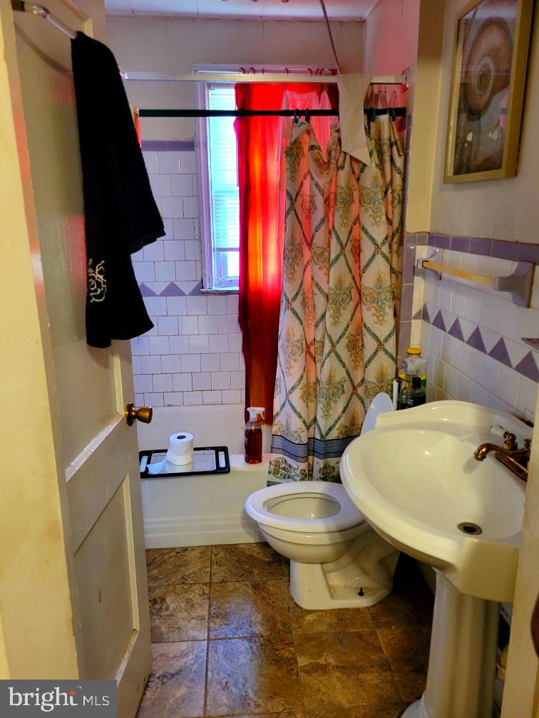 3582 Dudley Avenue Baltimore, MD 21213 - Photo 9 of 13 a bathroom with a sink and a mirror