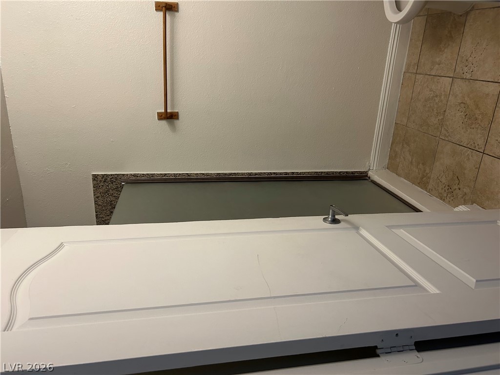 1852 North Decatur Boulevard, Unit 103 Las Vegas, NV 89108 - Photo 10 of 10 A well-maintained shower area featuring a durable tile wall and convenient glass enclosure.