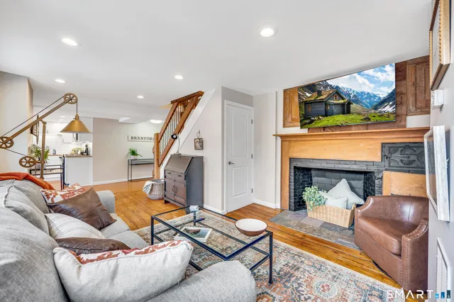 a bedroom with a bed a mirror on desk and chair