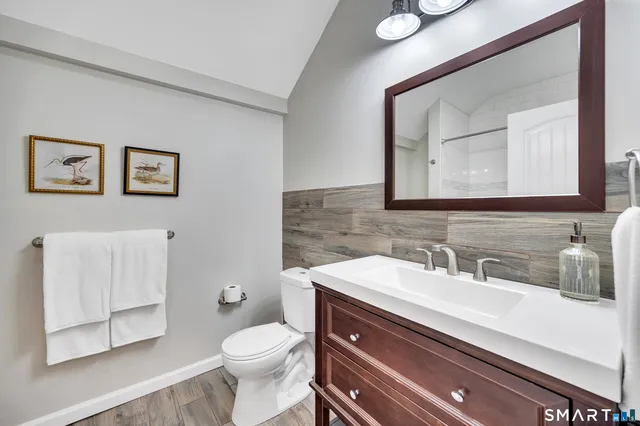 a bathroom with a toilet sink and mirror