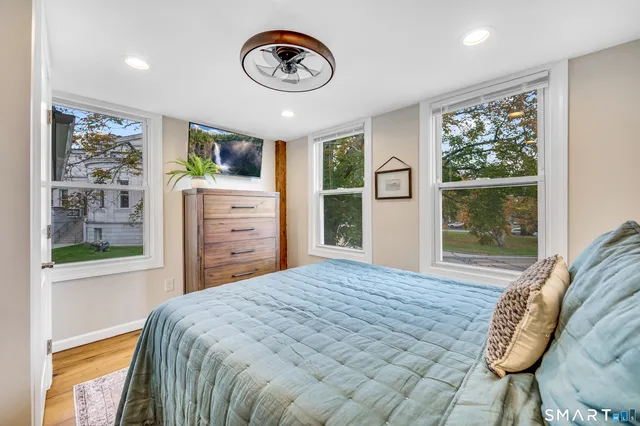 a bedroom with a bed and a window