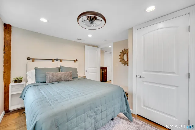 a bedroom with a bed and a tv